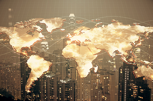 Map of the world superimposed on row of high rise buildings